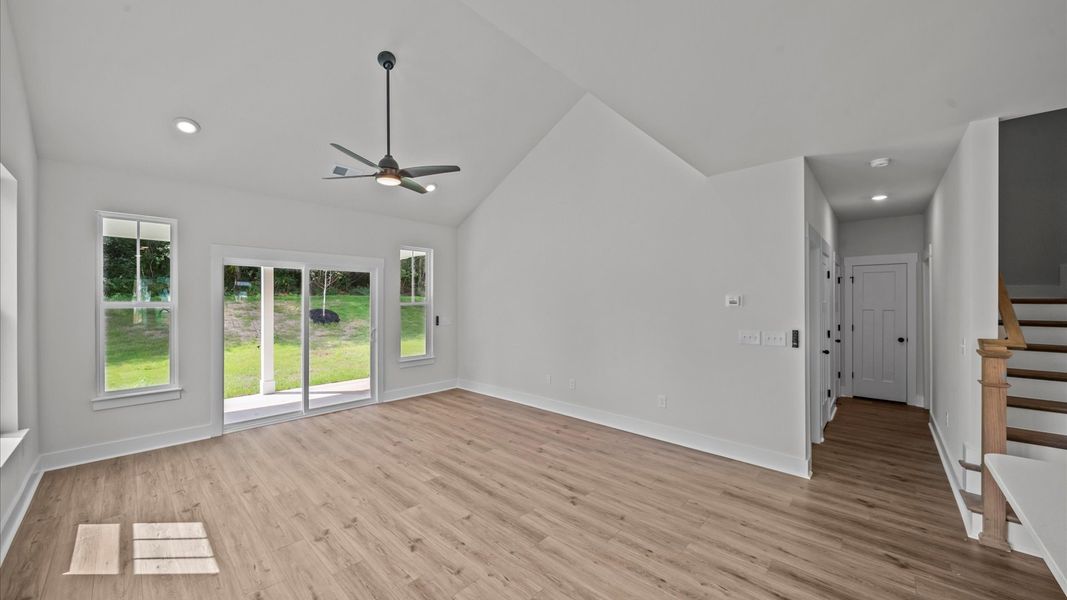 Tasteful family room with two-story volume, refined finishes, and exceptional natural light