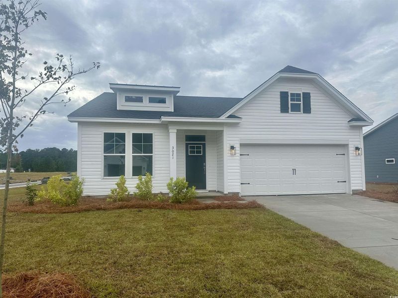 View of front of property featuring concrete driveway, a front yard, an attached garage, and roof with shingles