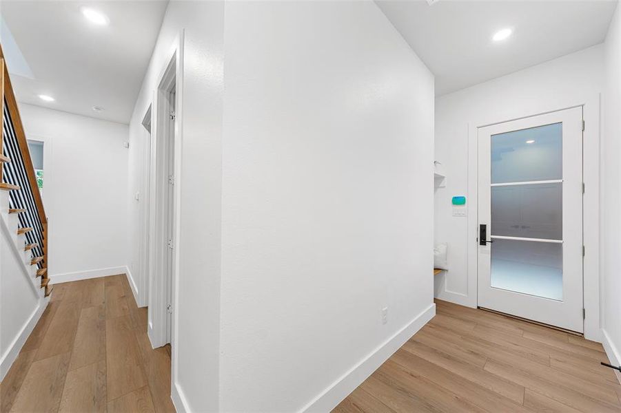 Corridor featuring light wood finished floors and recessed lighting Corridor featuring light wood finished floors and recessed lighting