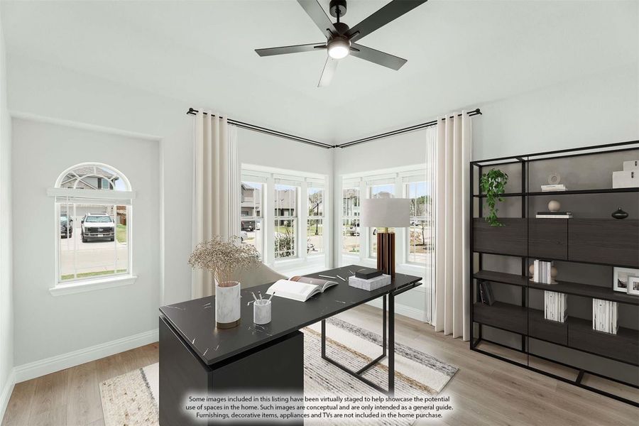 Home office with dark desk, ceiling fan, open shelving unit, and large windows with white curtains