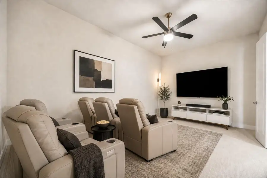 FIRST FLOOR ENTERTAINMENT ROOM OFFERS A GENEROUS LAYOUT, CEILING FAN, AND WALL SPACE IDEAL FOR A LARGE-SCREEN ENTERTAINMENT SETUP. **Virtually Staged. FIRST FLOOR ENTERTAINMENT ROOM OFFERS A GENEROUS LAYOUT, CEILING FAN, AND WALL SPACE IDEAL FOR A LARGE-SCREEN ENTERTAINMENT SETUP. **Virtually Staged.