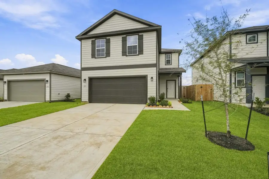Front exterior of a new home in Mirabella, Brookshire, TX, highlighting curb appeal (Image 1). Front exterior of a new home in Mirabella, Brookshire, TX, highlighting curb appeal (Image 1).