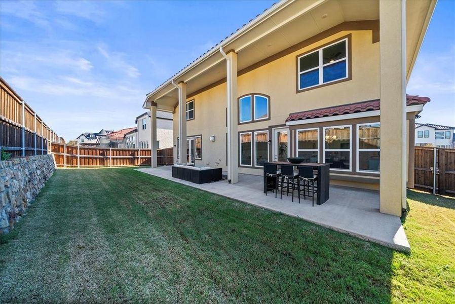Rear view of property featuring stucco siding, a fenced backyard, a patio, and an outdoor living space Rear view of property featuring stucco siding, a fenced backyard, a patio, and an outdoor living space
