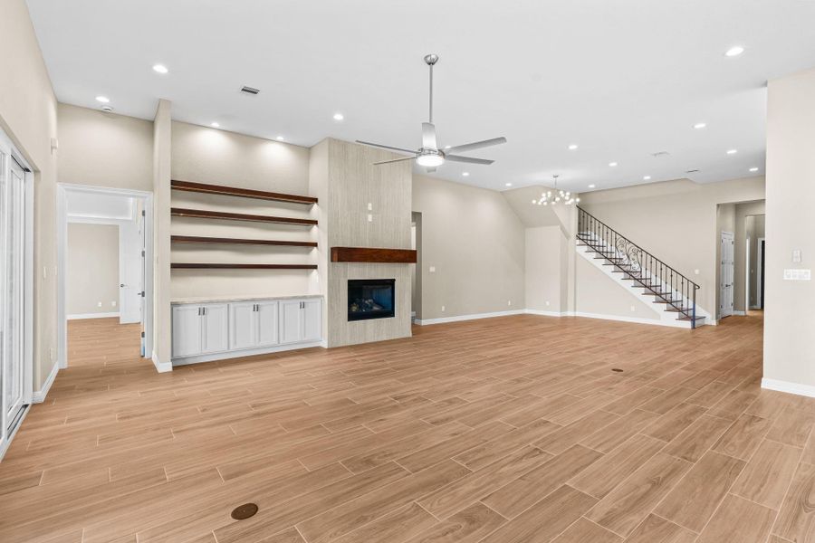 Alternate perspective of the main living area showing the elegant fireplace feature wall and spacious design.