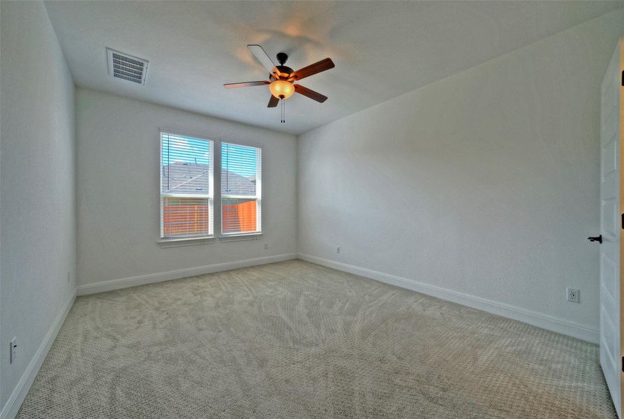 Soft carpeting pairs with clean white walls and double windows in this restful space. Soft carpeting pairs with clean white walls and double windows in this restful space.