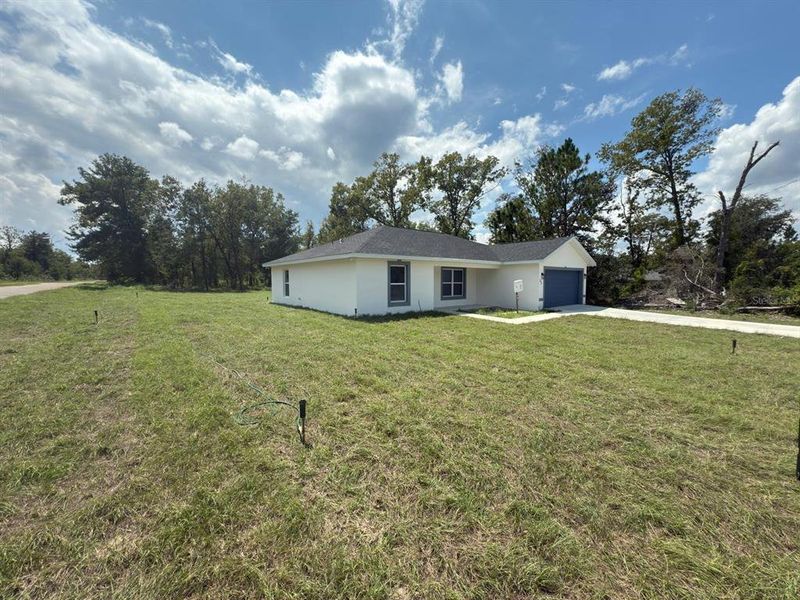 Front exterior of a new home in , Ocklawaha, FL, highlighting curb appeal (Image 2).