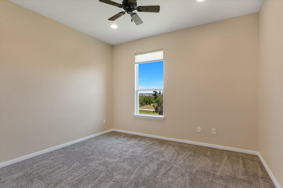 Bedroom 2 (un-staged) offers a beautiful greenbelt view!