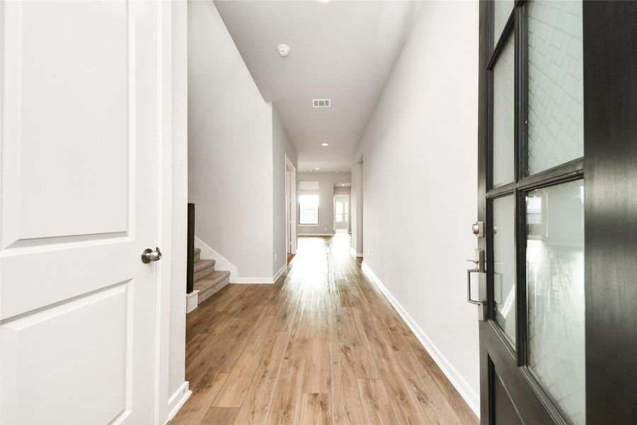 Bright hallway entry with modern flooring and natural light