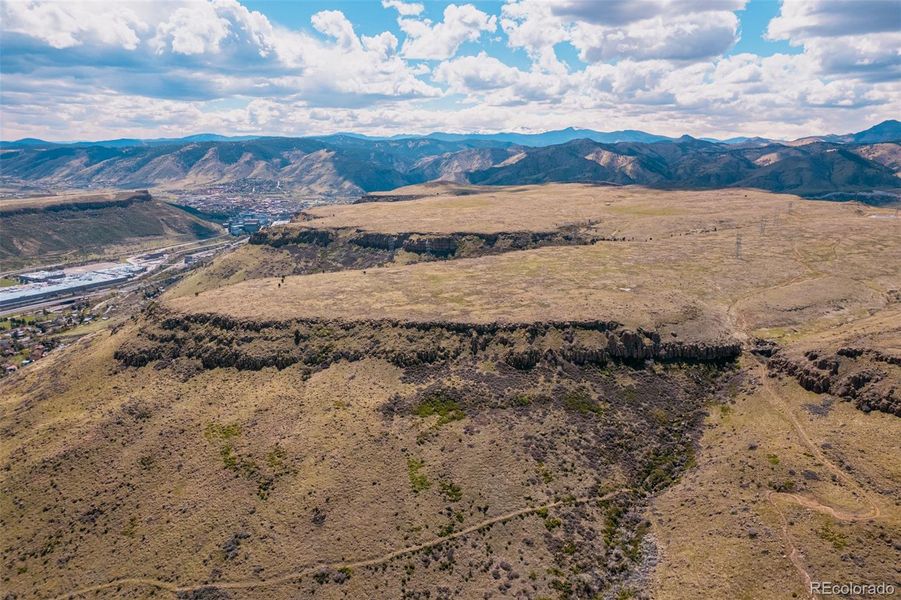 Formed by ancient lava flows nearly 60 million years ago, North Table Mountain and its sister mesa, South Table Mountain, rise dramatically above Golden as enduring landmarks. Today, visitors to North Table Mountain Park are rewarded with sweeping panoramic views, more than 15 miles of hiking and biking trails, and world-class rock climbing set against a striking geological backdrop.