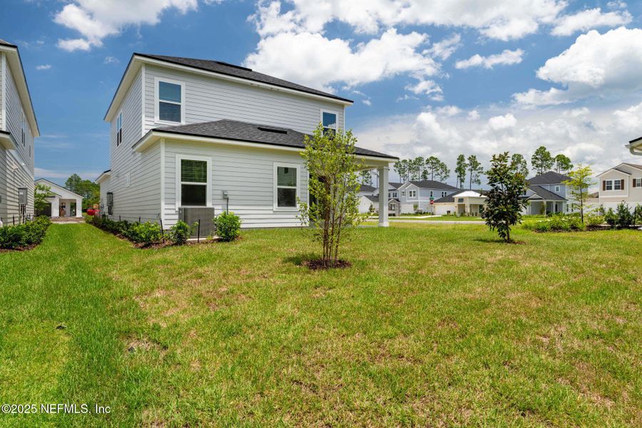 Front exterior of a new home in Beacon Lake, St. Augustine, FL, highlighting curb appeal (Image 35).