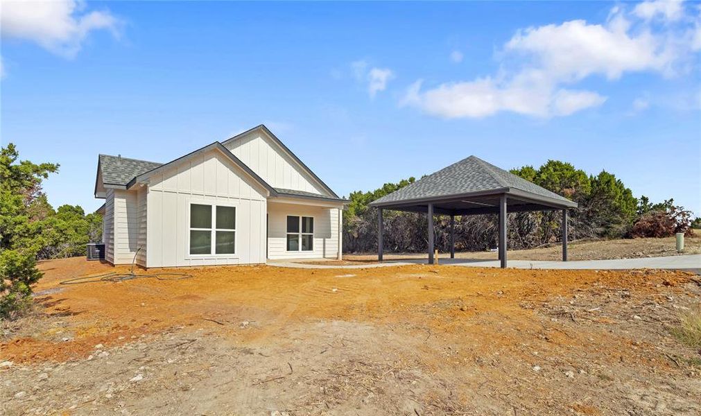 View of home's exterior with a shingled roof and board and batten siding View of home's exterior with a shingled roof and board and batten siding
