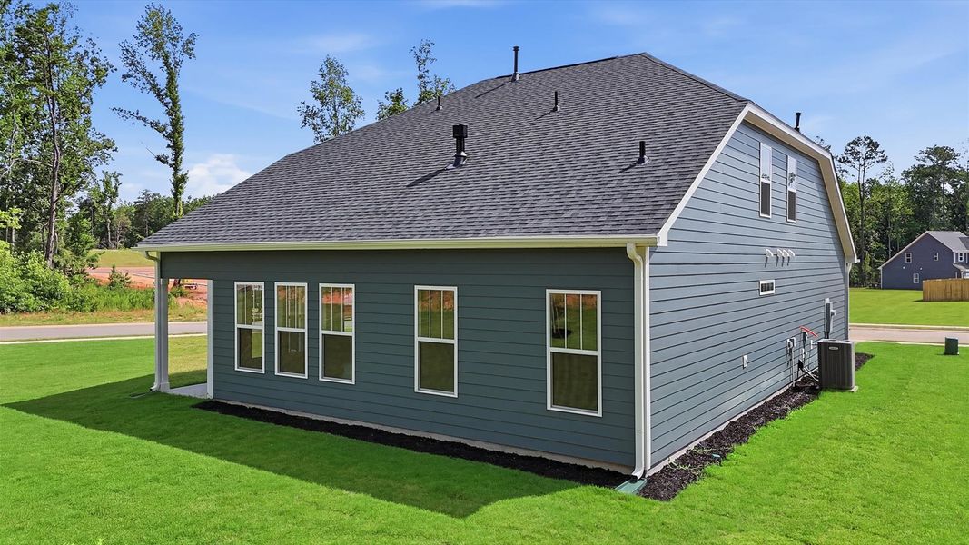 Notable exterior includes a rear covered porch designed for year-round enjoyment at Creeks at Midway