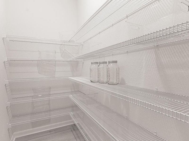 You will find convenient storage throughout, such as this walk-in pantry - Aspen townhome by Highland Homes You will find convenient storage throughout, such as this walk-in pantry - Aspen townhome by Highland Homes