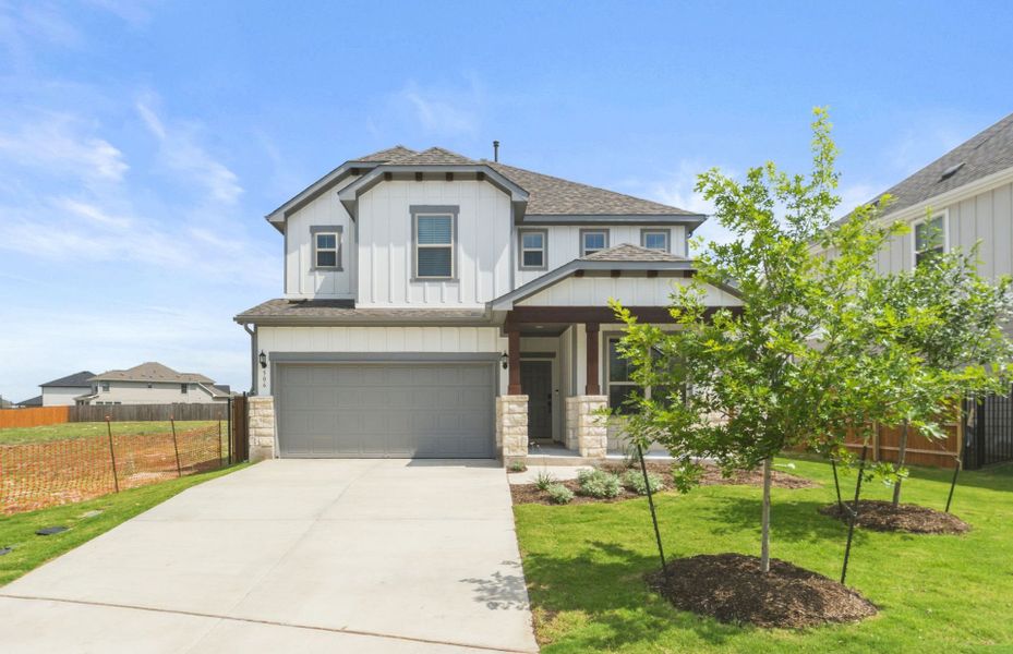 Front exterior of a new home in Santa Rita Ranch, Liberty Hill, TX, highlighting curb appeal (Image 24). Front exterior of a new home in Santa Rita Ranch, Liberty Hill, TX, highlighting curb appeal (Image 24).
