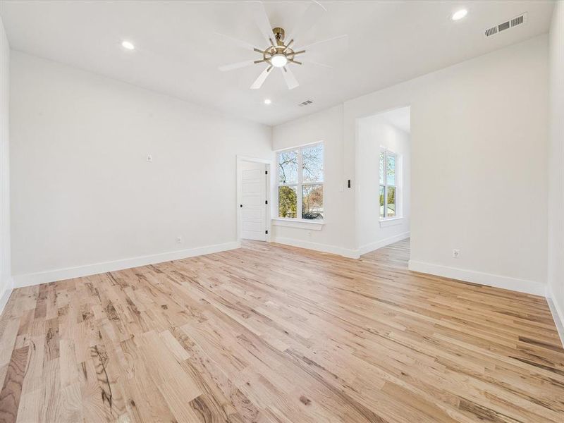 Spare room featuring ceiling fan and light wood-type flooring