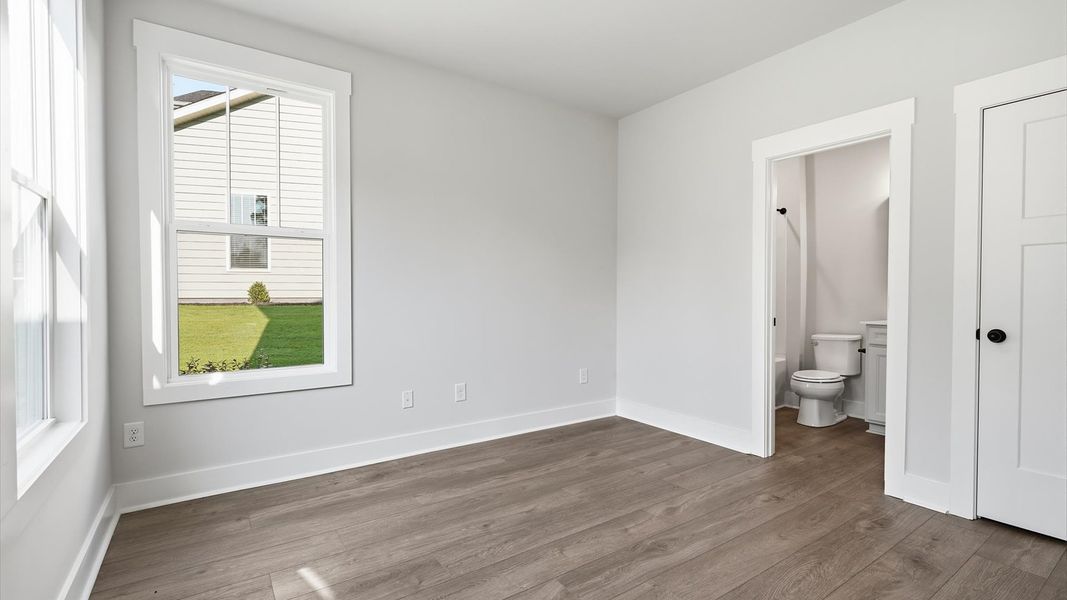 Hardwood flooring creates a warm and inviting guest space