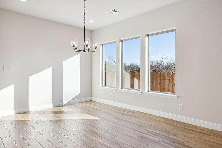 Unfurnished dining area featuring a chandelier