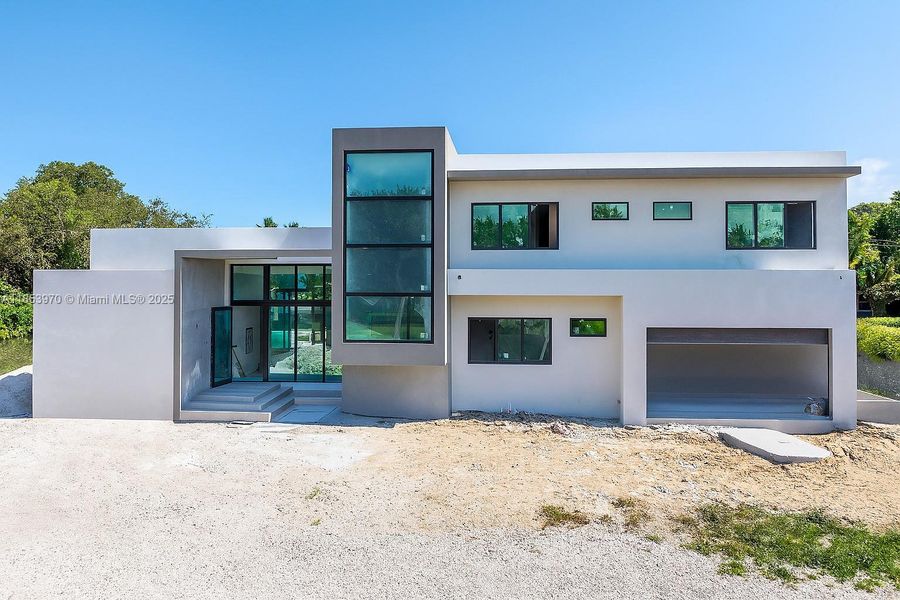 Front exterior of a new home in , Pinecrest, FL, highlighting curb appeal (Image 31). Front exterior of a new home in , Pinecrest, FL, highlighting curb appeal (Image 31).