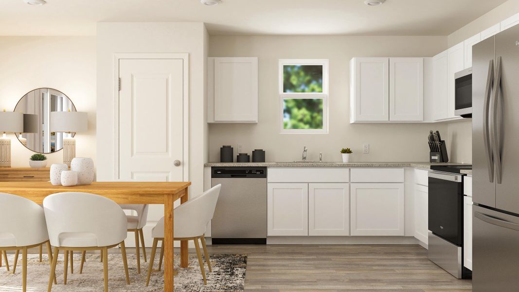 A kitchen with white cabinets.