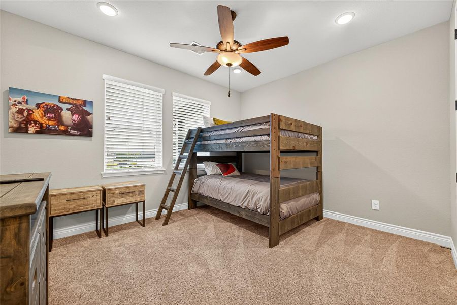 Spacious secondary bedroom with plush carpet, ceiling fan, and large closet — ideal for guests or children. Spacious secondary bedroom with plush carpet, ceiling fan, and large closet — ideal for guests or children.