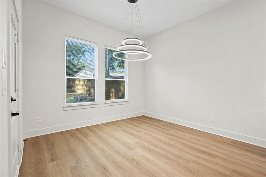 Unfurnished dining area with light wood-style floors and a chandelier
