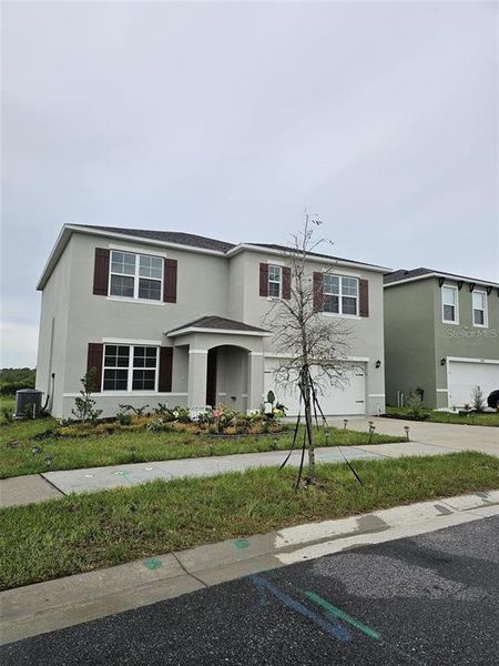 Front exterior of a new home in , Haines City, FL, highlighting curb appeal (Image 2).