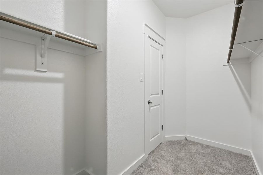 Walk in closet with light colored carpet Walk in closet with light colored carpet