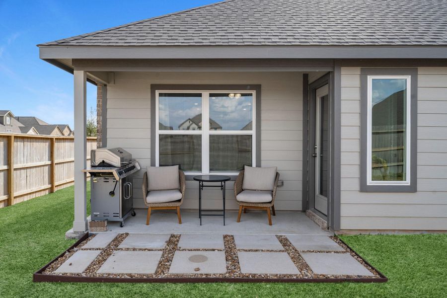 The covered patio is generously sized, providing ample space for various outdoor activities.