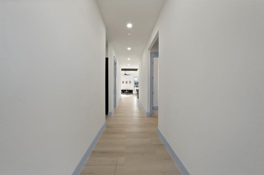 Corridor with recessed lighting and light wood finished floors