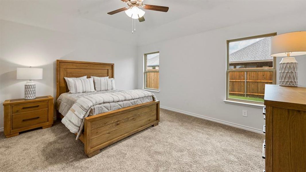 Bedroom with light colored carpet and ceiling fan