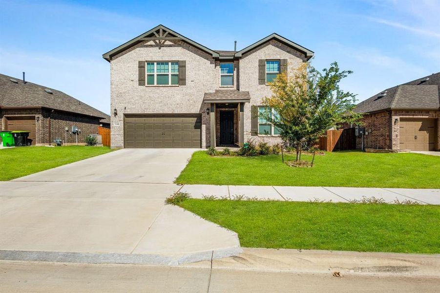 View of front of home featuring concrete driveway, brick siding, and an attached garage View of front of home featuring concrete driveway, brick siding, and an attached garage