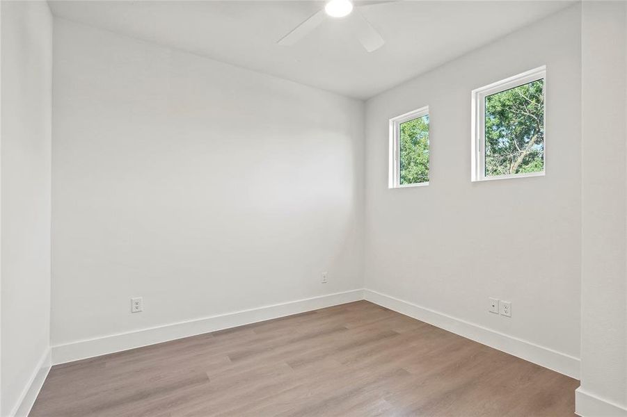 Unfurnished room featuring a ceiling fan and light wood-style floors