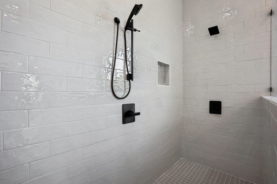 Full bath featuring tiled shower