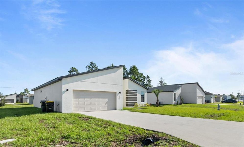 Front exterior of a new home in , Kissimmee, FL, highlighting curb appeal (Image 21).