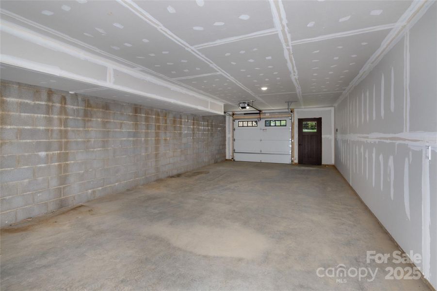 Tandem two car garage with equipment/tool and/or additional storage on lower level