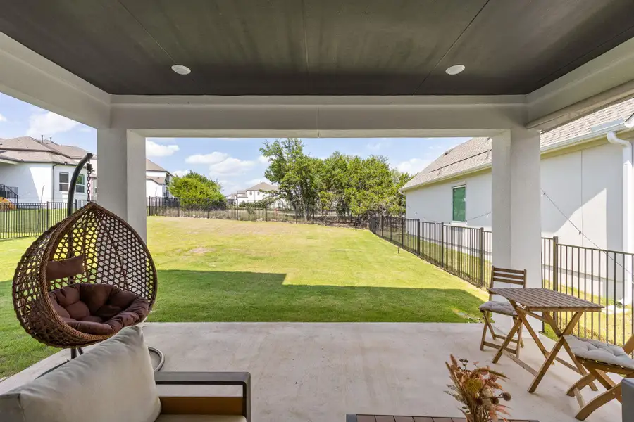 Covered patio with a dark-paneled ceiling featuring recessed lighting