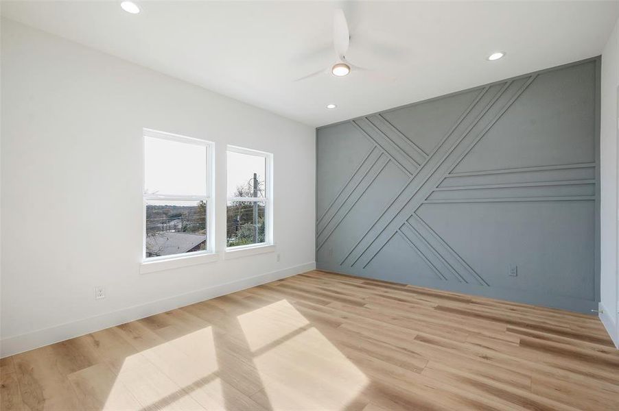 Unfurnished room featuring light hardwood / wood-style floors and ceiling fan