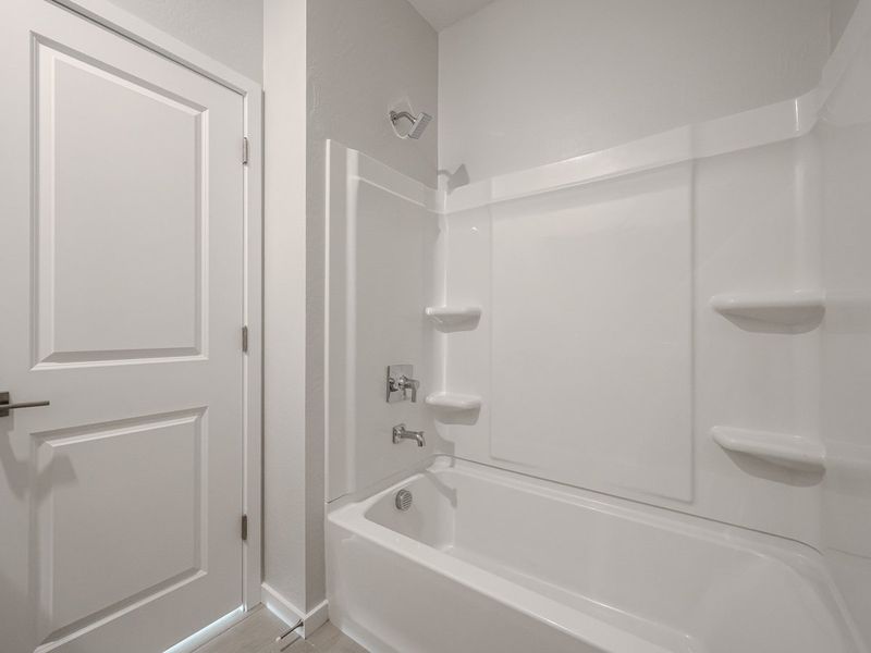 A bathroom with a bathtub sink and toilet.