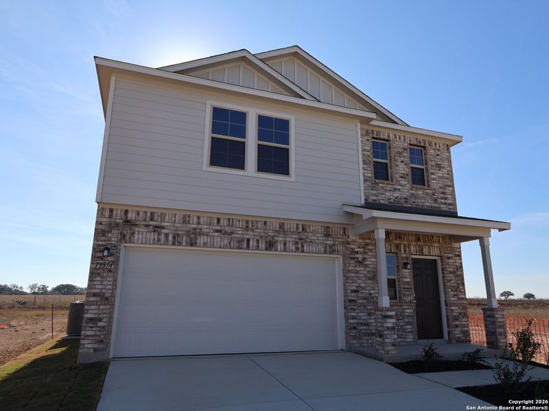 Front exterior of a new home in Winding Brook, San Antonio, TX, highlighting curb appeal (Image 21).
