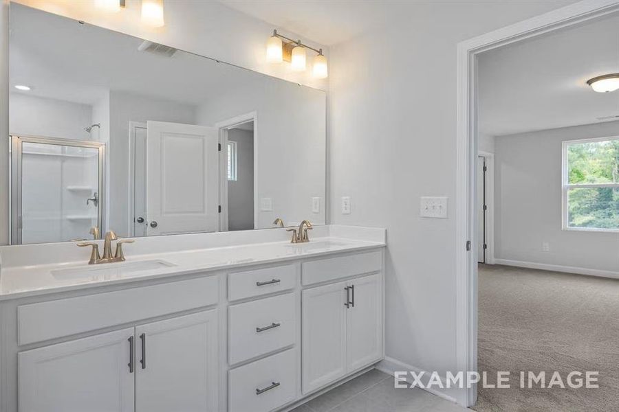 Bathroom featuring vanity and an enclosed shower