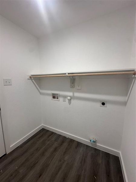 Clothes washing area featuring gas dryer hookup, hookup for an electric dryer, dark hardwood / wood-style floors, and washer hookup