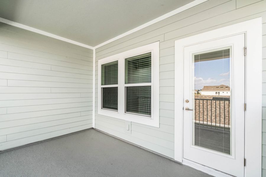Exterior details and patio area of a home in Harvest at Ovation - Townhomes, Winter Garden (Image 2).