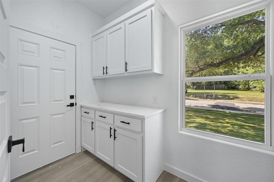 Doorway featuring wood finished floors and baseboards Doorway featuring wood finished floors and baseboards
