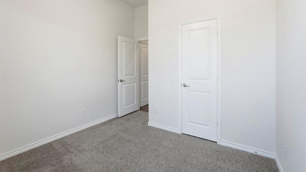 Unfurnished bedroom with carpet and baseboards Unfurnished bedroom with carpet and baseboards