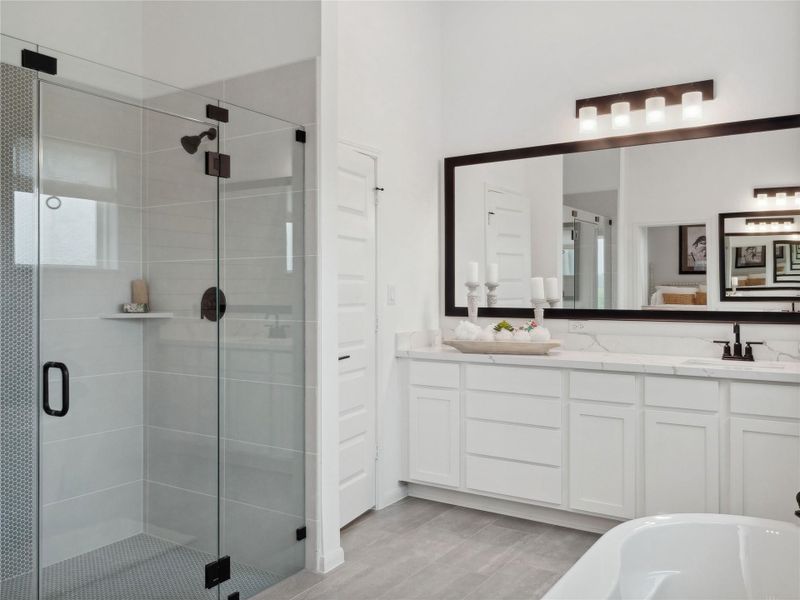 Dual sinks, separate shower and tub in primary bath (*Photo not of actual home and used for illustration purposes only.)