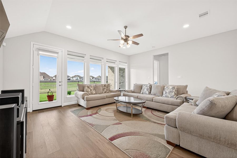 Expansive family room showcasing a dramatic wall of windows that bathes the space in natural light, creating an elegant and inviting atmosphere. The open-concept design seamlessly connects the living areas, offering the perfect setting for luxurious entertaining and comfortable everyday living. Expansive family room showcasing a dramatic wall of windows that bathes the space in natural light, creating an elegant and inviting atmosphere. The open-concept design seamlessly connects the living areas, offering the perfect setting for luxurious entertaining and comfortable everyday living.