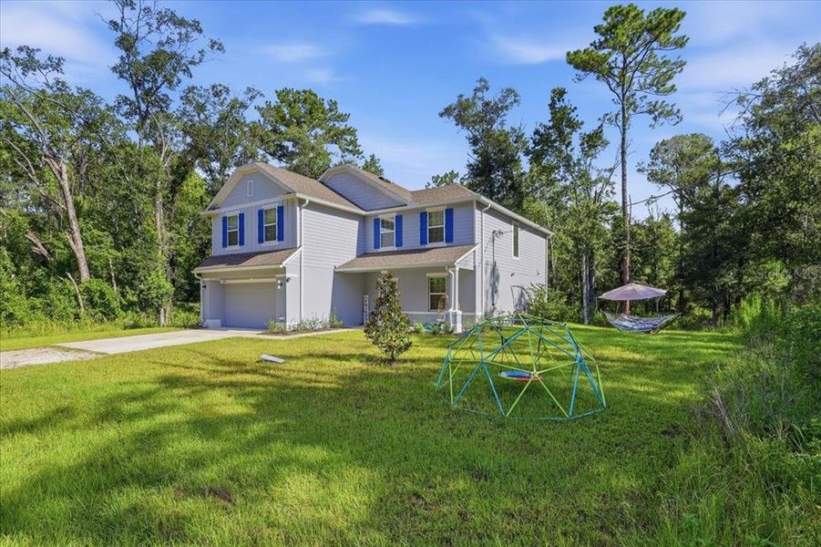 Front exterior of a new home in Flagler Estates, Hastings, FL, highlighting curb appeal (Image 27).