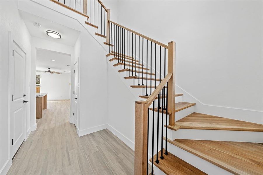 Stairway with baseboards and wood finished floors