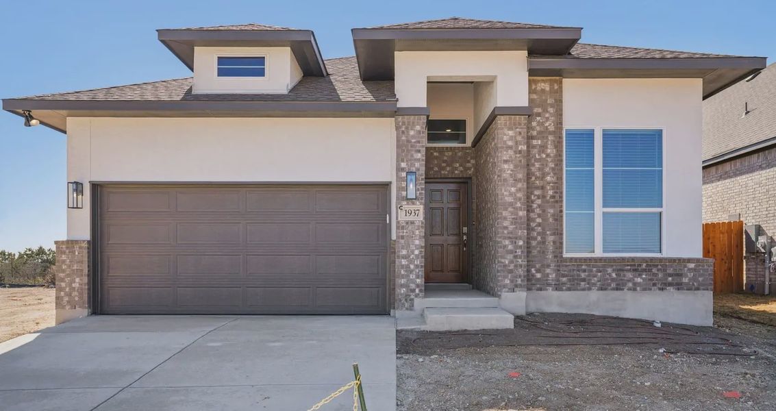Front exterior of a new home in Meyer Ranch, New Braunfels, TX, highlighting curb appeal (Image 1). Front exterior of a new home in Meyer Ranch, New Braunfels, TX, highlighting curb appeal (Image 1).