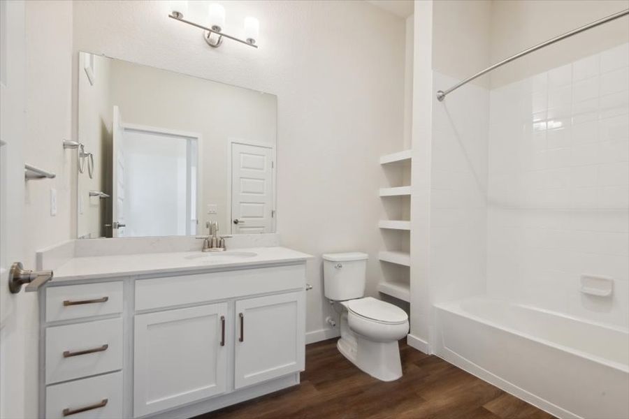 A bathroom with a toilet and sink. A bathroom with a toilet and sink.